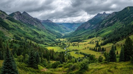 Fototapeta premium Panoramic mountain valley vista. Lush green valley nestled between towering, rugged peaks under a cloudy sky. A winding river flows through the valley floor