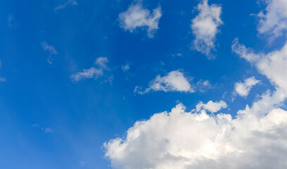 Vivid blue sky illustrating Rayleigh scattering. Cumulus cloud formations indicate atmospheric convection & fair weather. Ideal for meteorology & climate background.
