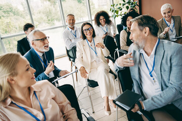 Diverse workplace team engaged in an interactive business meeting together at a modern office setting, promoting teamwork.