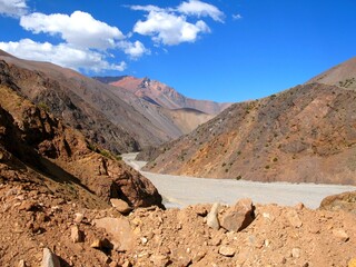 Arid mountain valley on the route to Cerro Mercedario in Argentina’s Andes under a deep blue sky.