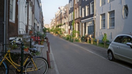 Blurred street scene in amsterdam highlighting defocused bicycles and urban architecture in a...