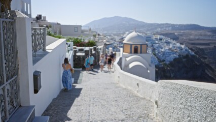 Sunlit defocused whitewashed coastal village walkway with domed architecture and cliffside view...