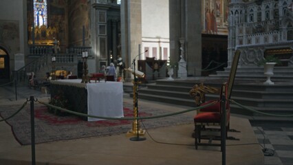 Church with defocused altar and soft shallow bokeh, ornate steps and lectern in the frame; background backdrop copyspace.