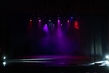Spotlights in the concert hall. Stage light with colored spotlights and smoke.