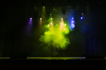 Spotlights in the concert hall. Stage light with colored spotlights and smoke.