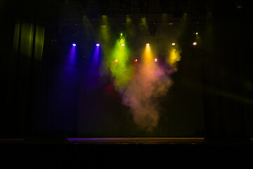 Spotlights in the concert hall. Stage light with colored spotlights and smoke.