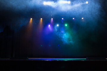Spotlights in the concert hall. Stage light with colored spotlights and smoke.