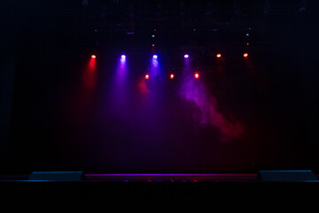 Spotlights in the concert hall. Stage light with colored spotlights and smoke.