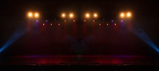 Spotlights in the concert hall. Stage light with colored spotlights and smoke.