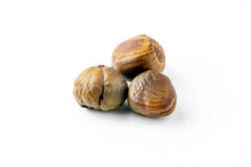 Close-up of fresh brown chestnuts isolated on white background, showing natural texture and detail....