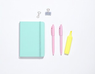 Colorful stationery set featuring a pink notebook, teal stapler, and pen arranged neatly on a clean surface