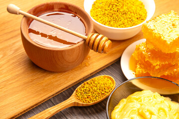 Delicious honey and bee products displayed on a wooden surface for culinary delight
