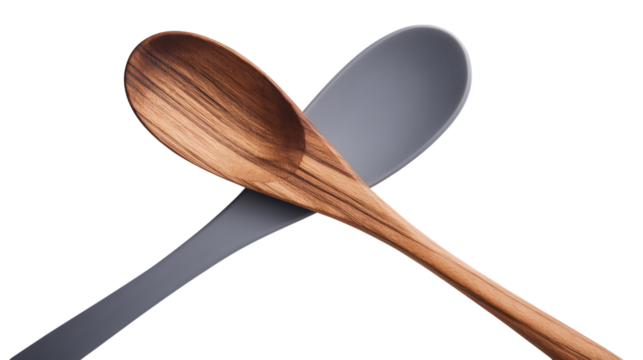Two kitchen spoons one wooden and one silicone crossed against a black background