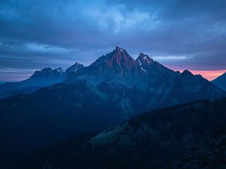Fototapeta premium Majestic mountain peaks under a dramatic twilight sky
