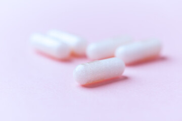 Carnitine capsules on paper background. Soft focus. Close up. Copy space.	