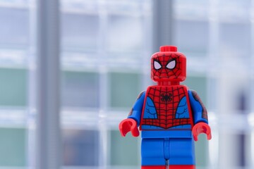 Naklejka premium Tambov, Russian Federation - January 24, 2025 Lego Spiderman minifigure standing in front of office building. Close-up