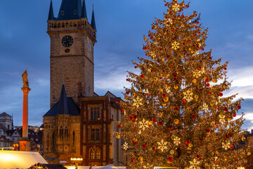 Christmas tree glowing in Old Town Square Prague at dusk