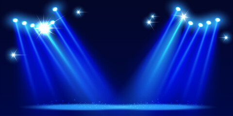 Bright blue concert spotlights create the effect of shining stars on the stage.