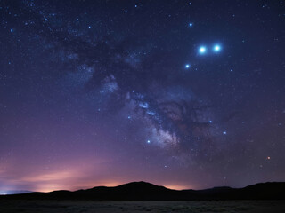 Fototapeta premium Breathtaking Milky Way galaxy arches across a vibrant night sky above silhouetted mountains, inspiring wonder and cosmic awe.