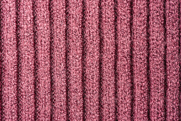 Burgundy knitted background. Burgundy fabric texture macro photo as background.