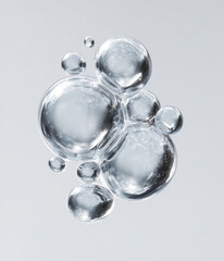 Water bubbles forming abstract liquid shape in clear background