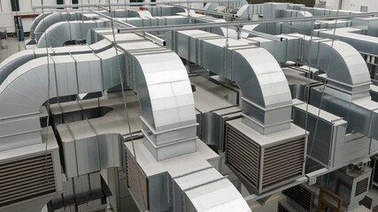 Overhead HVAC ductwork system with metal air conditioning conduits for commercial use - Powered by Adobe