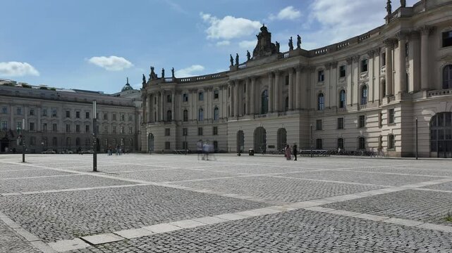 Bebelplatz with Jura Library on the right side in Berlin,Germany, wide angle shot time lapse with motion blur of people, summer 2024