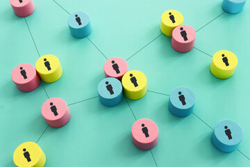 Wooden figures and cubes with connecting lines. Idea of collaboration and teamwork