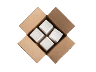 Overhead shot showing a brown cardboard box with four white, square objects nestled inside
