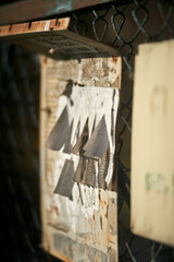 Torn Tear-Off Flyer on Rusty Chain-Link Fence