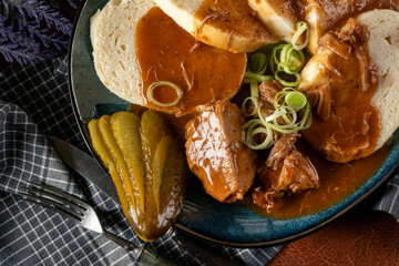 Czech dumplings with stewed pork in sauce.