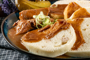 Czech dumplings with stewed pork in sauce.
