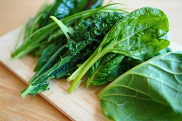 Fresh assortment of leafy greens including kale, spinach, and chard