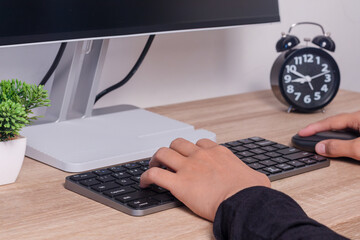 Female hands on computer keyboard and mouse. Working or studying on computer.