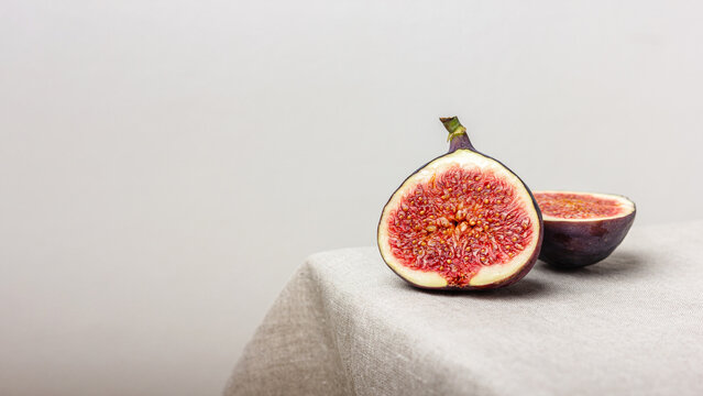 Fresh cut figs on a light background.