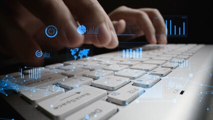 A close-up view of hands typing on a laptop keyboard, with vibrant data visualizations and graphs overlaid, symbolizing technology, data analysis, and business insights. Xenic