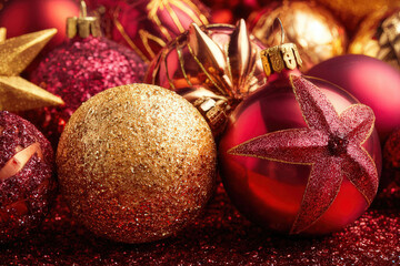 Festive Christmas ornaments in shades of red and gold, holiday season decorations.