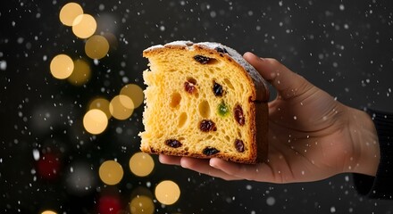 Hand Holding Panettone in Snowfall &ndash; Festive Christmas Bread with Golden Lights