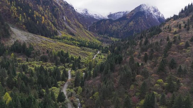 Aerial Drone Footage Flying Through Mountain Valley with Dirt Road Sichuan, China