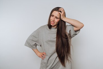 Fototapeta premium Woman with long hair looking confused and scratching her head