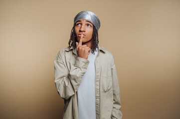 Young person in casual attire pondering with a thoughtful expression.