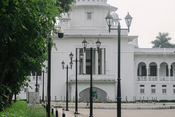 View of the Supreme Court of Bangladesh through Row of Black Lamp Posts in Dhaka, Bangladesh.