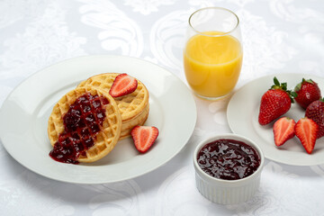 Delicious Breakfast Waffles with Strawberries and Orange Juice