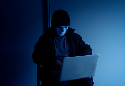 hacker, scammer at the dark room