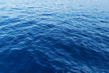 Vast blue ocean waves under clear sky