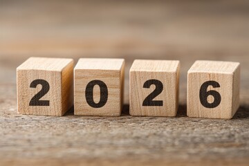 Wooden blocks spell out the year 2026 representing future goals planning and new year celebrations on a rustic wood background