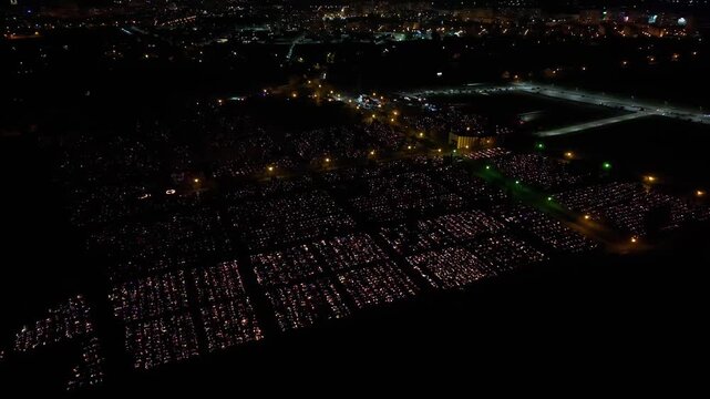 Aerial view of a Polish cemetery on All Saints&rsquo; Night, glowing with thousands of candles that honor the dead and illuminate the darkness with warmth and faith.