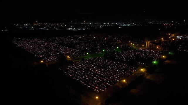 Aerial view of a Polish cemetery on All Saints&rsquo; Night, glowing with thousands of candles that honor the dead and illuminate the darkness with warmth and faith.