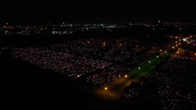 Aerial view of a Polish cemetery on All Saints&rsquo; Night, glowing with thousands of candles that honor the dead and illuminate the darkness with warmth and faith.