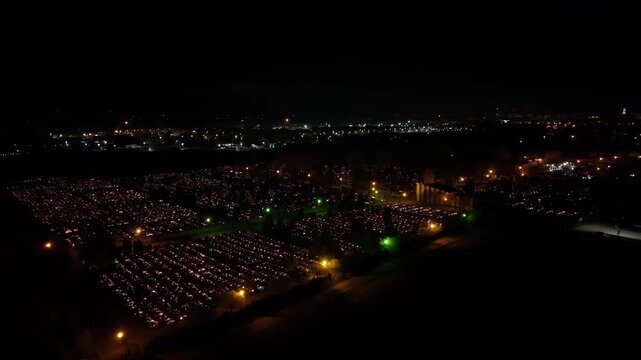 Aerial view of a Polish cemetery on All Saints&rsquo; Night, glowing with thousands of candles that honor the dead and illuminate the darkness with warmth and faith.